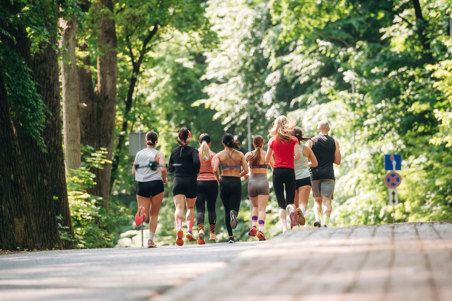 Front view. Group of runners are together outdoors